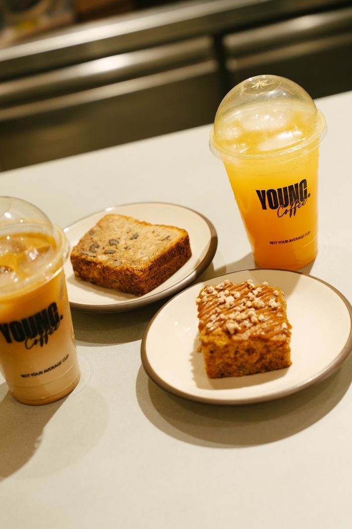 Two iced YOUNG Coffee drinks and pastries on the counter