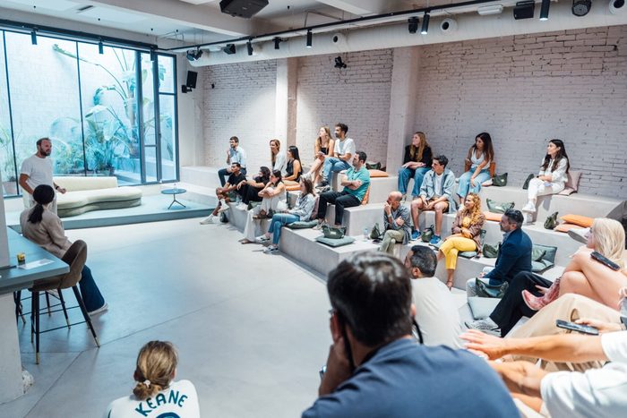 A room full of people listening to a talk at a YOUNG event