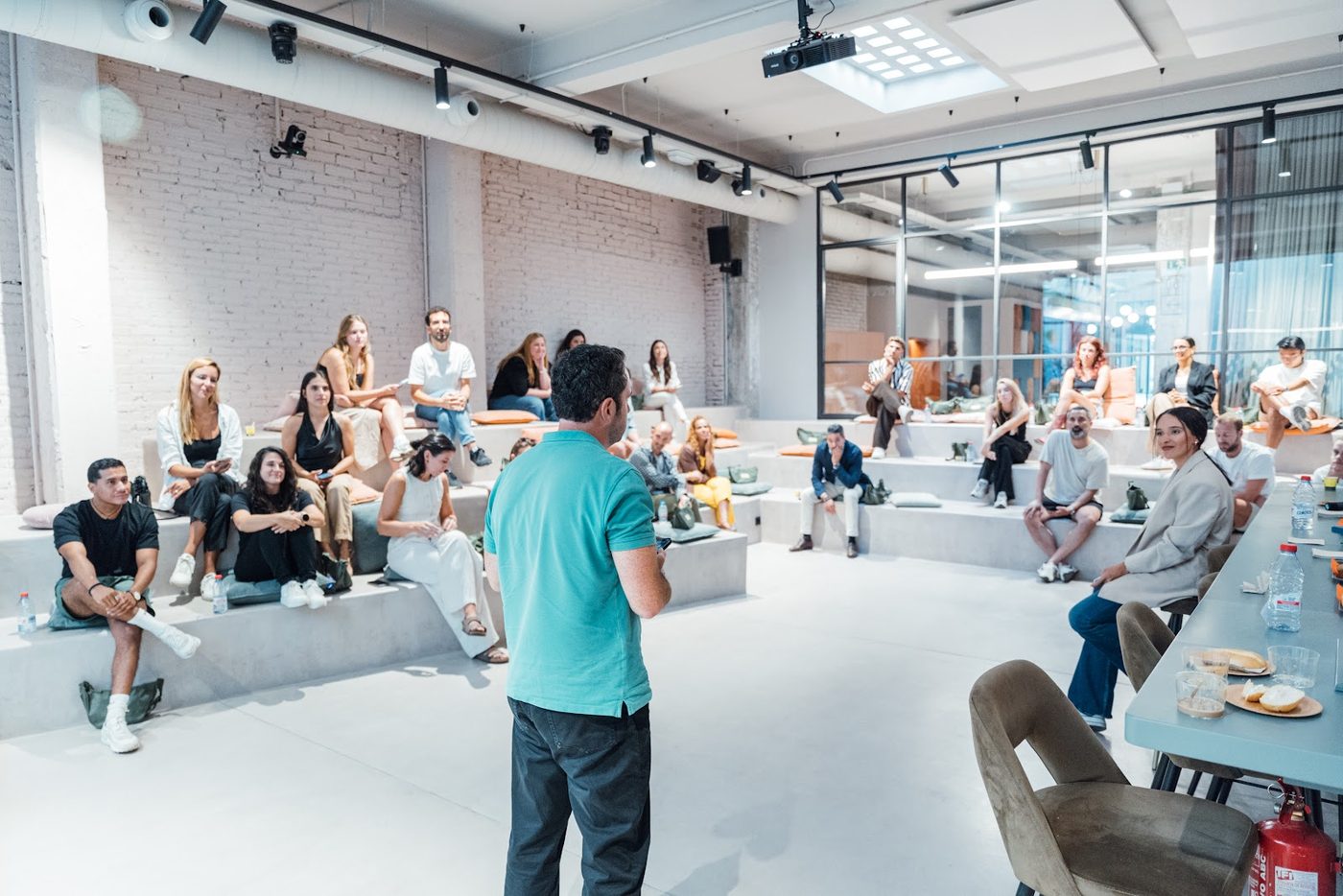 A talk at YOUNG Weekend, the room seated on steps and benches