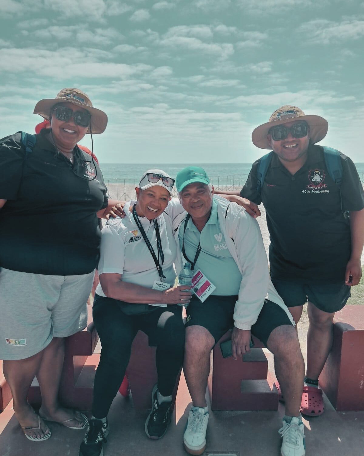 Four volunteers on the beach in Cape Town, South Africa