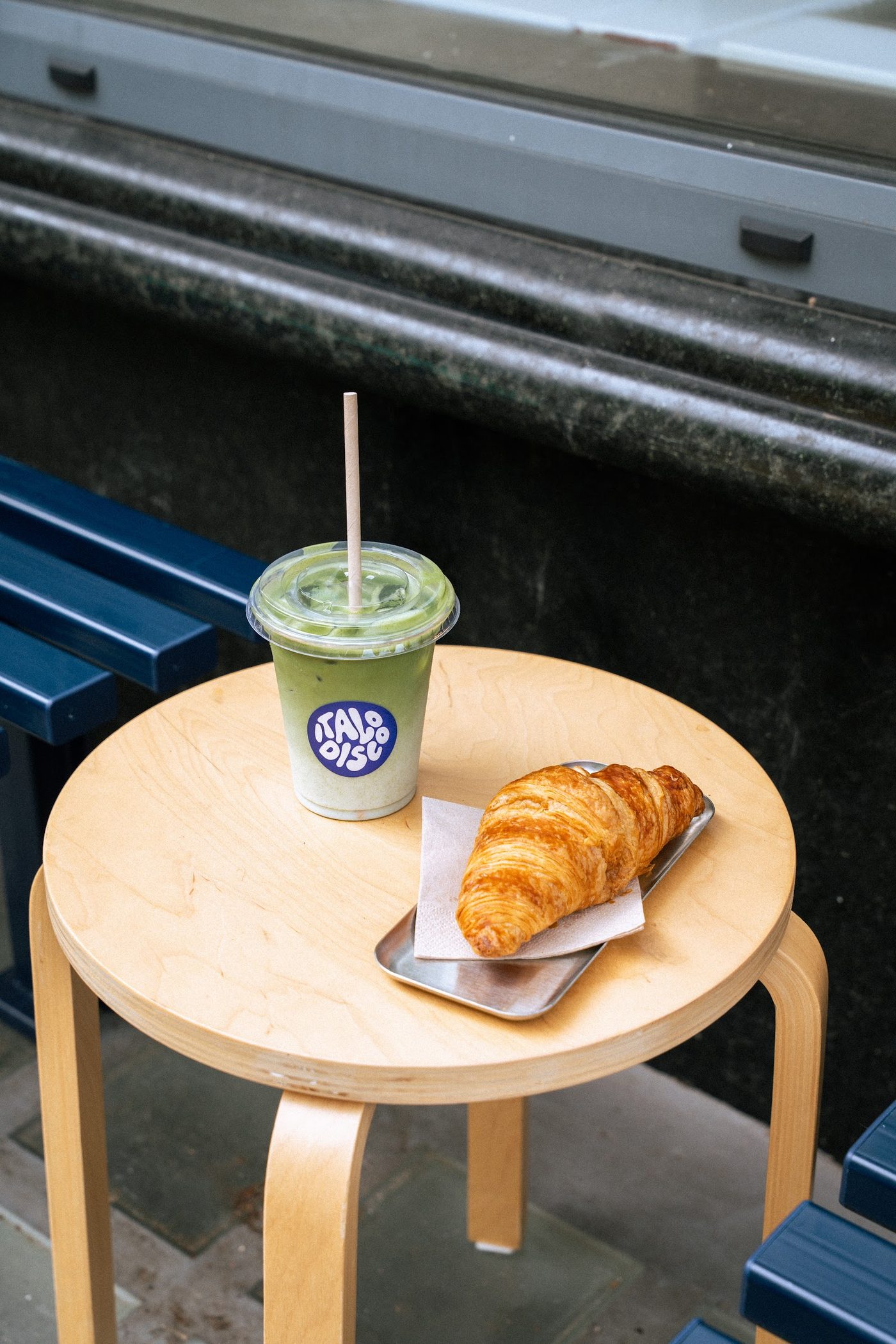 An iced drink and a croissant on a table at YOUNG Coffee