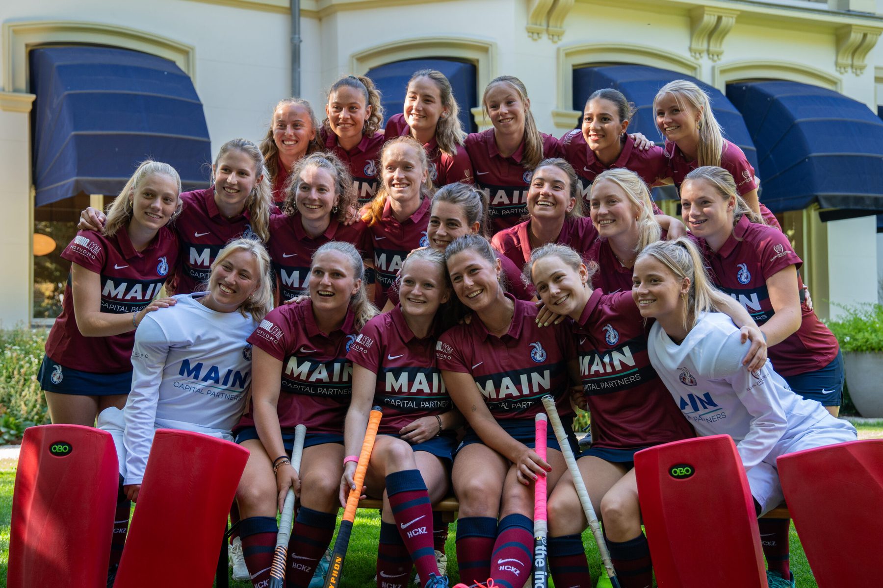 The KZ girls hockey team in maroon YOUNG kit