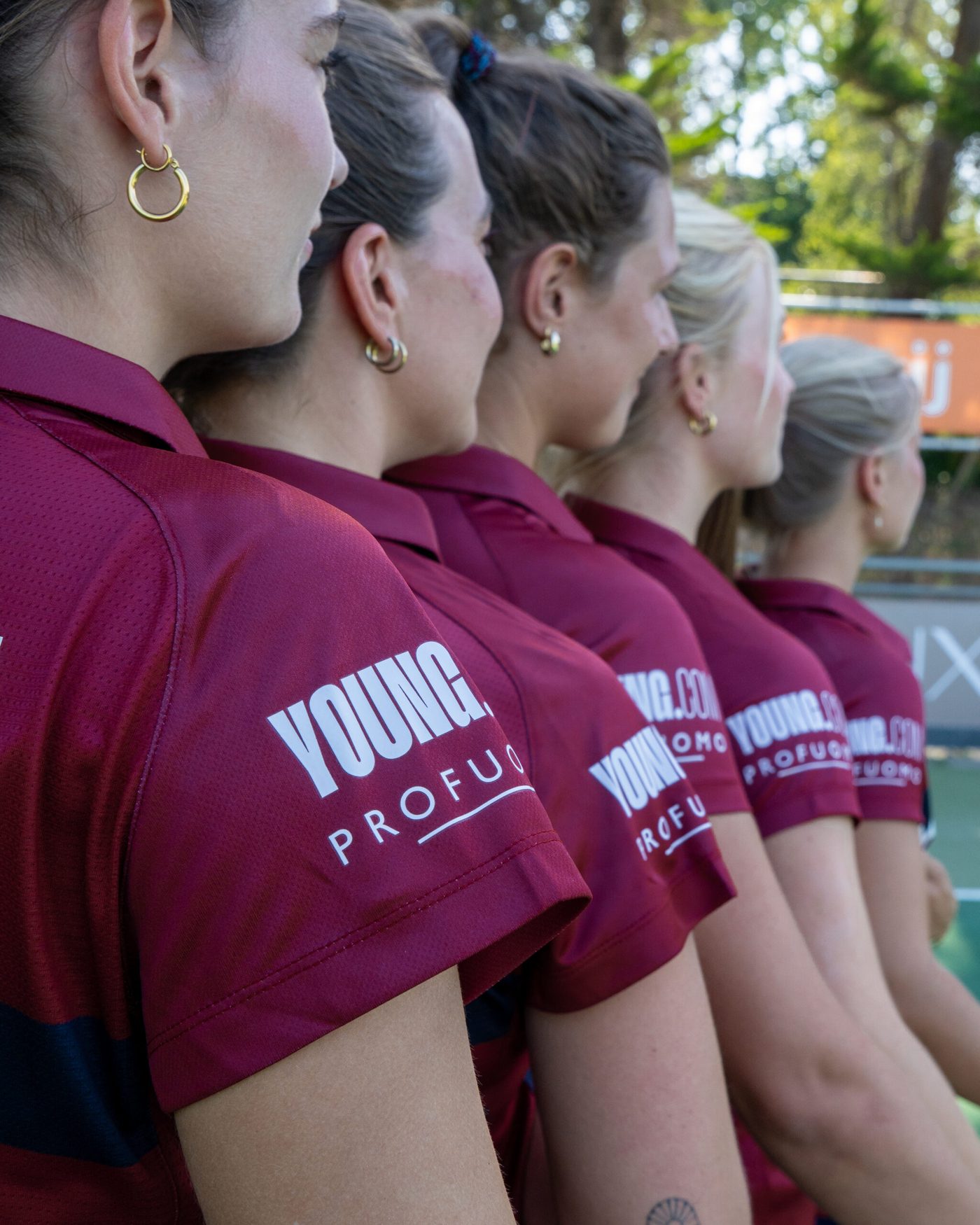 Close-up of the YOUNG.COM logo on a maroon sleeve