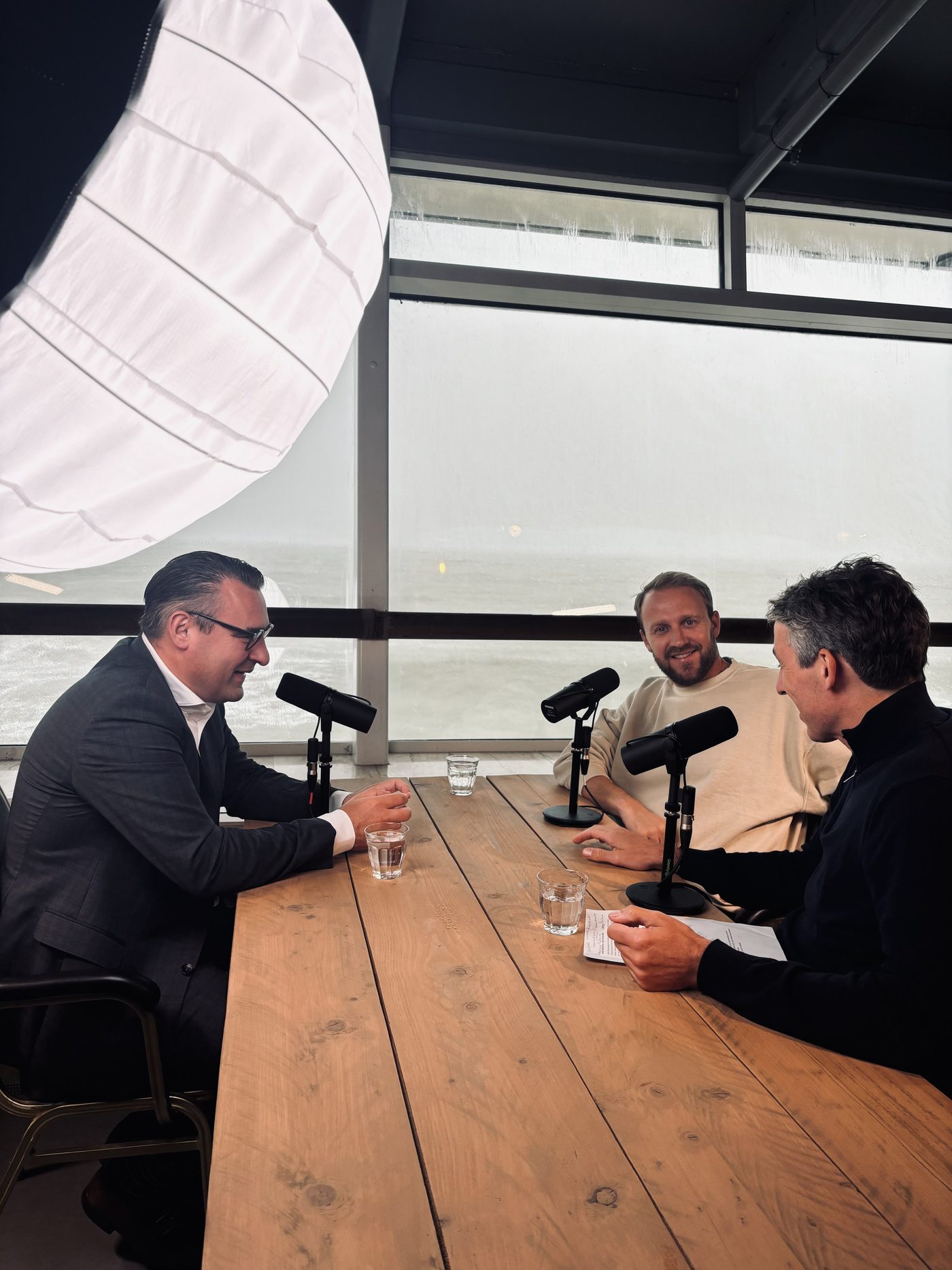 Recording a YOUNG podcast at a table by the sea