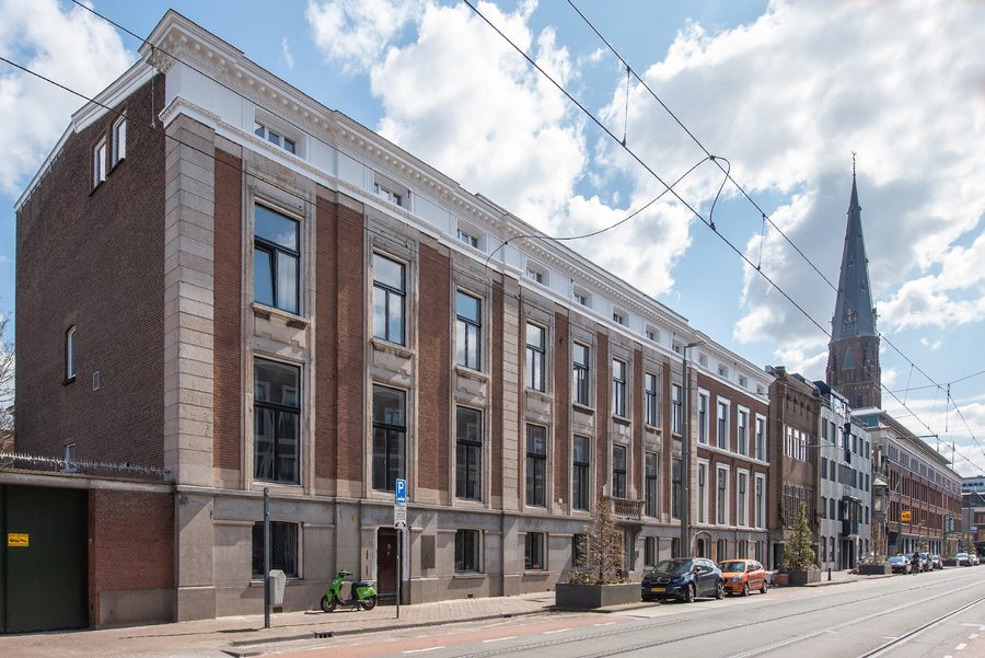 A YOUNG building on a street corner