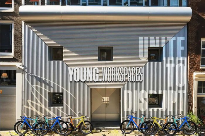 A YOUNG.Workspaces building with Unite to disrupt painted on the wall