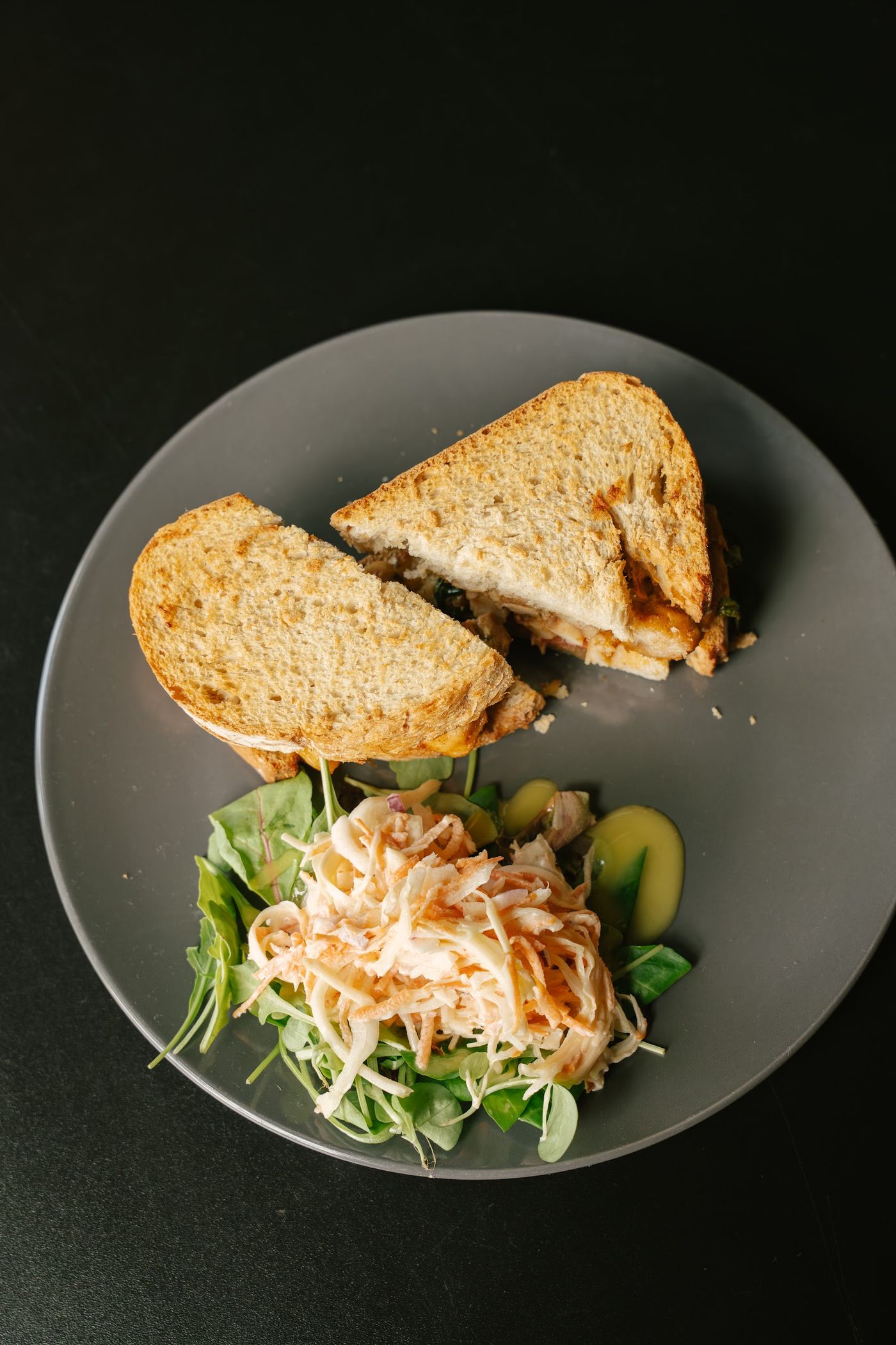 A sandwich and a salad on a table