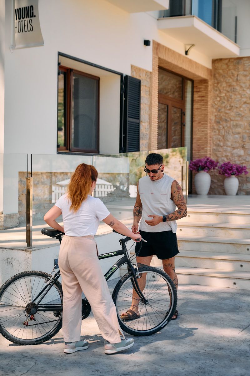 Two members with a bike outside a YOUNG hotel